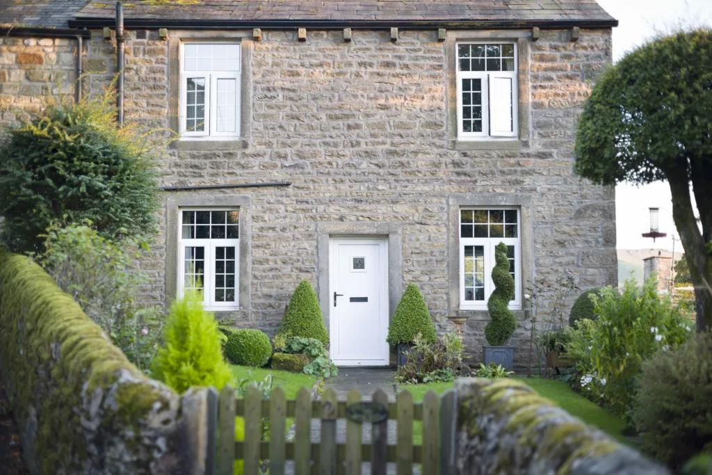 Period stone cottage with timber windows and front door