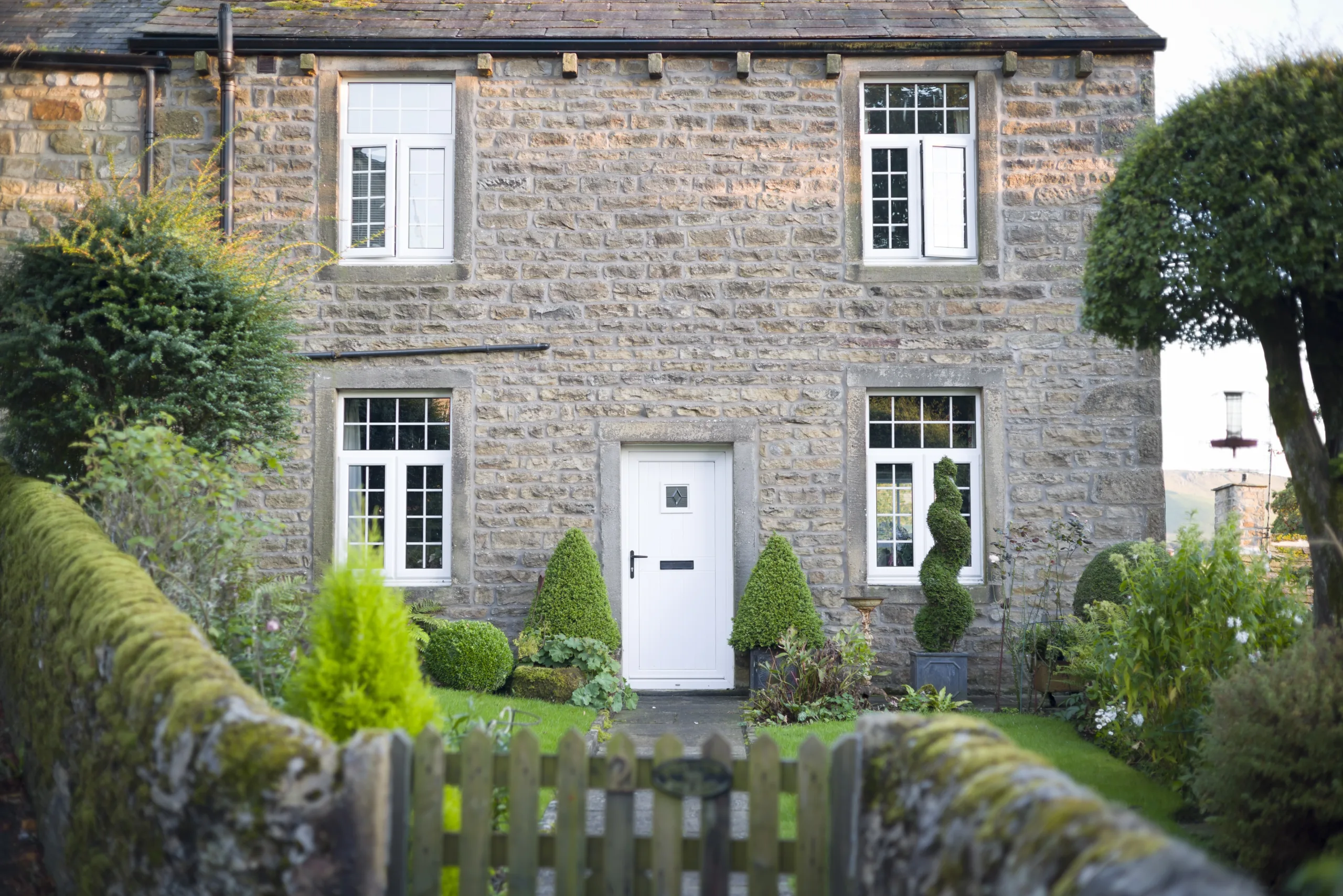 Period stone cottage with timber windows and front door